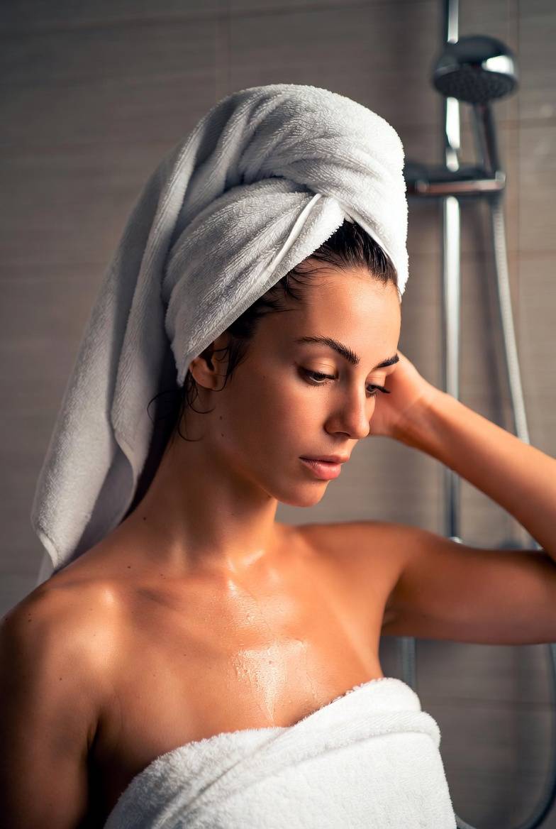 Woman washing her hair in the shower — is it advisable to wash hair every day?