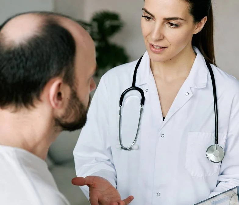 Trichologist examining a patient's scalp during a hair loss consultation