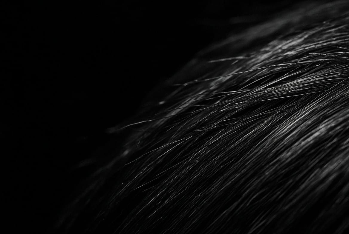 Close-up macro shot of dark hair strands texture